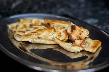 grilled chicken meat on a silver platter