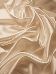 Beautiful smooth elegant wavy beige / light brown satin silk luxury cloth fabric texture, abstract background design. Copy space.