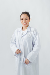 Portrait of young woman doctor with white coat standing