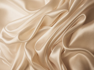 Obraz premium Beautiful smooth elegant wavy beige / light brown satin silk luxury cloth fabric texture, abstract background design. Copy space.
