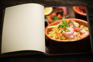 A vintage menu book and image as insert. Coscous fish