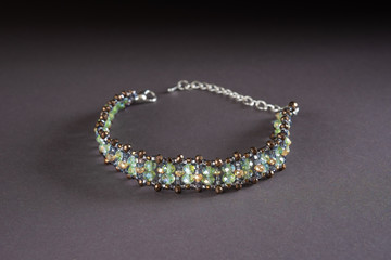 Hand made beaded bracelet on the background