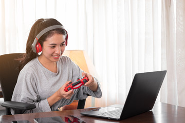 Young woman is playing games at home.