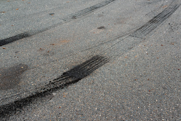Track of burnt tire on asphalt.