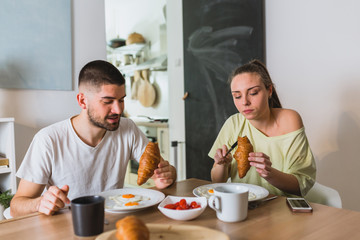 romantic man and woman couple having breakfast at home