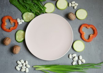 Obraz na płótnie Canvas Vegan menu, vegetarian food on a gray background, top view