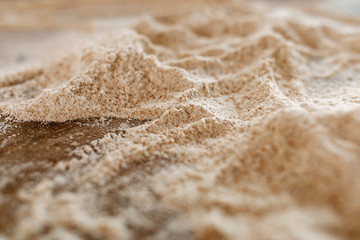 Close-up of flour on a wooden table.