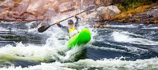 Abwaschbare Fototapete Banner whitewater kayaking, extreme sport rafting. Guy in kayak sails mountain river © Parilov