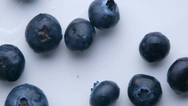 blueberries falling in super slow motion to the white table top view from above in slow motion from 120 fp