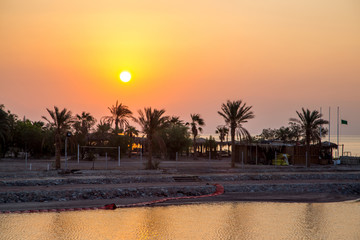 
Dawn off the coast of the Red Sea on the Jordanian coast in spring morning shot from the water with a general plan.