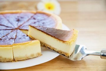 New York cheesecake on white wooden table - homemade cooking bakery concept
