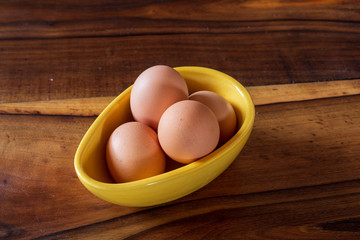 eggs on a bowl old wooden background, empty copy space