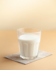  A glass of milk close-up on a brown background. The concept of farm dairy products, the use of milk. Copy space.