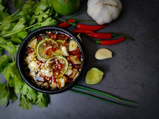 chili fish sauce with rawmaterial on black background 