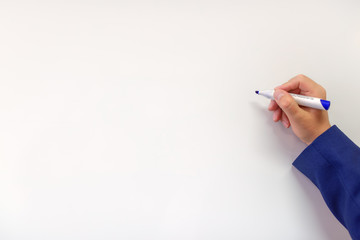 Marker held in hand near an blank white board.