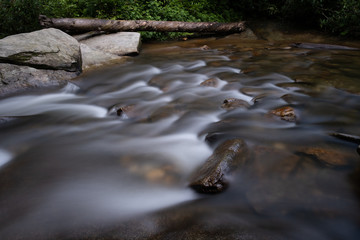 Stream cascading over river stones at Sliding Rock, a popular waterfall and destination in Brevard, near Asheville, North Carolina in the Blue Ridge Mountains.