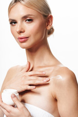 Obraz na płótnie Canvas Image of beautiful young shirtless woman applying body cream