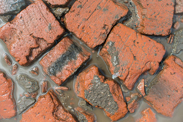 Top view of dirt red bricks texture background. Bricks, dirt water and ground