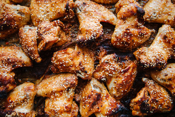Baked pickled chicken wings. Sprinkled with sesame seeds on top.