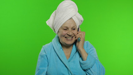 Elderly grandmother after shower. Old woman talking on mobile phone. Chroma key