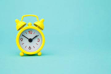 Yellow alarm clock Isolated on blue trendy background. Rest hours time of life good morning night...