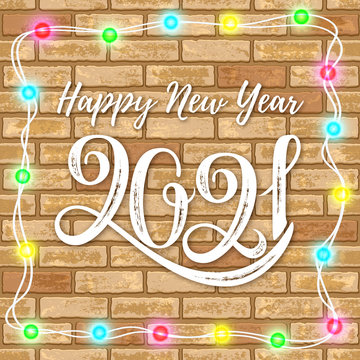 Lettering 2021 with garland on brick wall