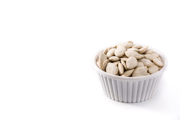  Pumpkin seeds in bowl isolated on white background. Copy space