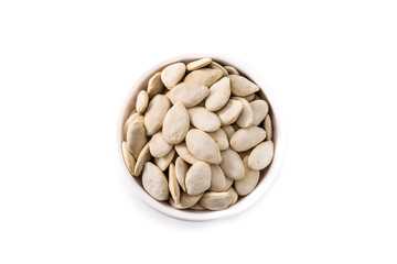  Pumpkin seeds in bowl isolated on white background. Top view