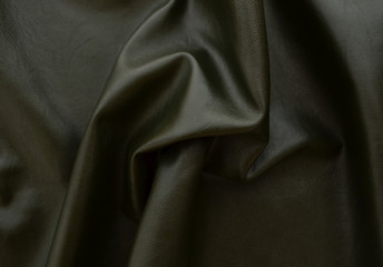 Dark background Leather fabric khaki color.