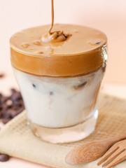 Dalgona frothy coffee trend korean drink with milk on pink pastel background