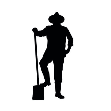 Silhouette of farmer posing with a shovel