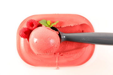 raspberry ice cream in box and spoon