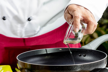 Chef poured oil into the pan.