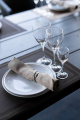 Served wooden table with three empty wineglasses