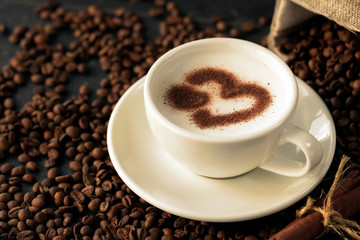 Heart shaped latte art on a coffee bean background