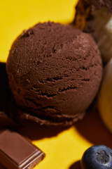 close up view of tasty brown ice cream with blueberry and chocolate