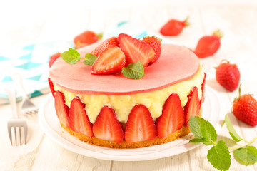 strawberry cake with cream on wood background