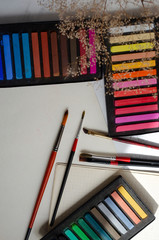 crayons of art pastels on a table with tassels