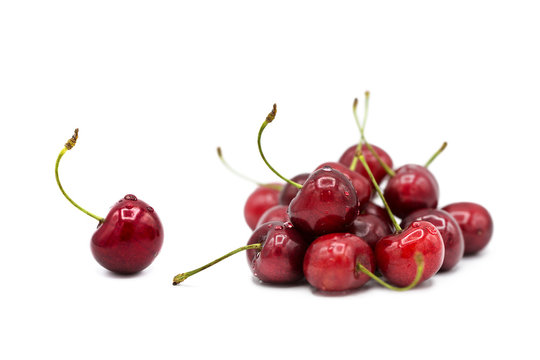 Ripe fresh organic cherries in dew drops isolated on white background