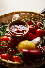 delicious tomato sauce with fresh ripe vegetables in basket