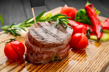 Grilled bbq steak with potato cube and tomatoes.
