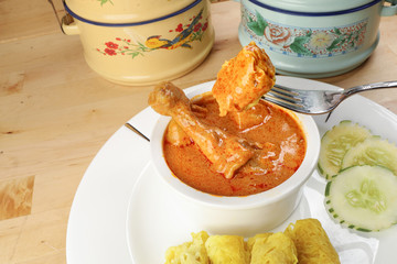 Traditional Malay snack food Roti Jala served with curry chicken with potato on white ceramic plate and bowl
