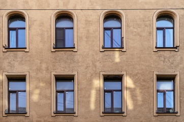 Fototapeta na wymiar Windows of old buildings in Saint Petersburg, background-symmetry in buildings. 