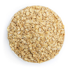 Oat flakes in a bowl  isolated on white background. Pile of oatmeal  top view