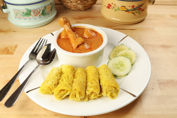 Traditional Malay snack food Roti Jala served with curry chicken with potato on white ceramic plate and bowl
