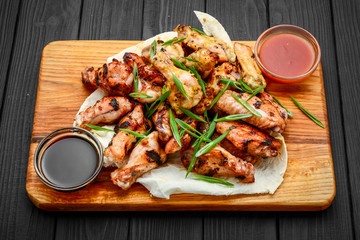 chicken wings and legs on a wooden table