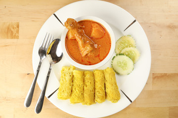 Traditional Malay snack food Roti Jala served with curry chicken with potato on white ceramic plate and bowl