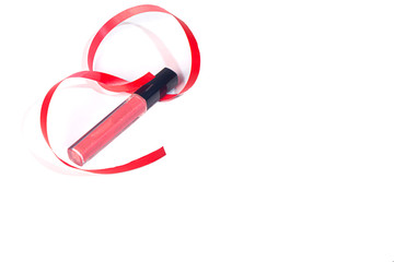 Pink lip gloss on a white background with a red ribbon. Isolate