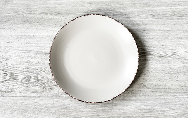 Plate on a wooden background close-up. 