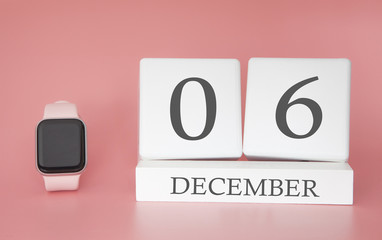 Modern Watch with cube calendar and date 06 december on pink background. Concept winter time vacation.